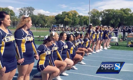 Members of the Buena Vista cheer team, including Alyssa Parker, kneel during the game on Sept. 30, 2017, against Luther College at J. Leslie Rollins Stadium in Storm Lake, Iowa. (KCCI-TV screenshot)